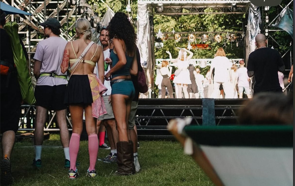 Crowd dancing in front of the stage at sunset
